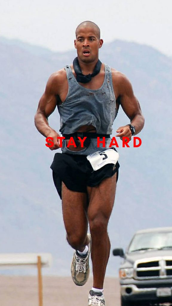 David Goggins high-intensity fitness wallpaper in grey tank top with Stay Hard overlay background