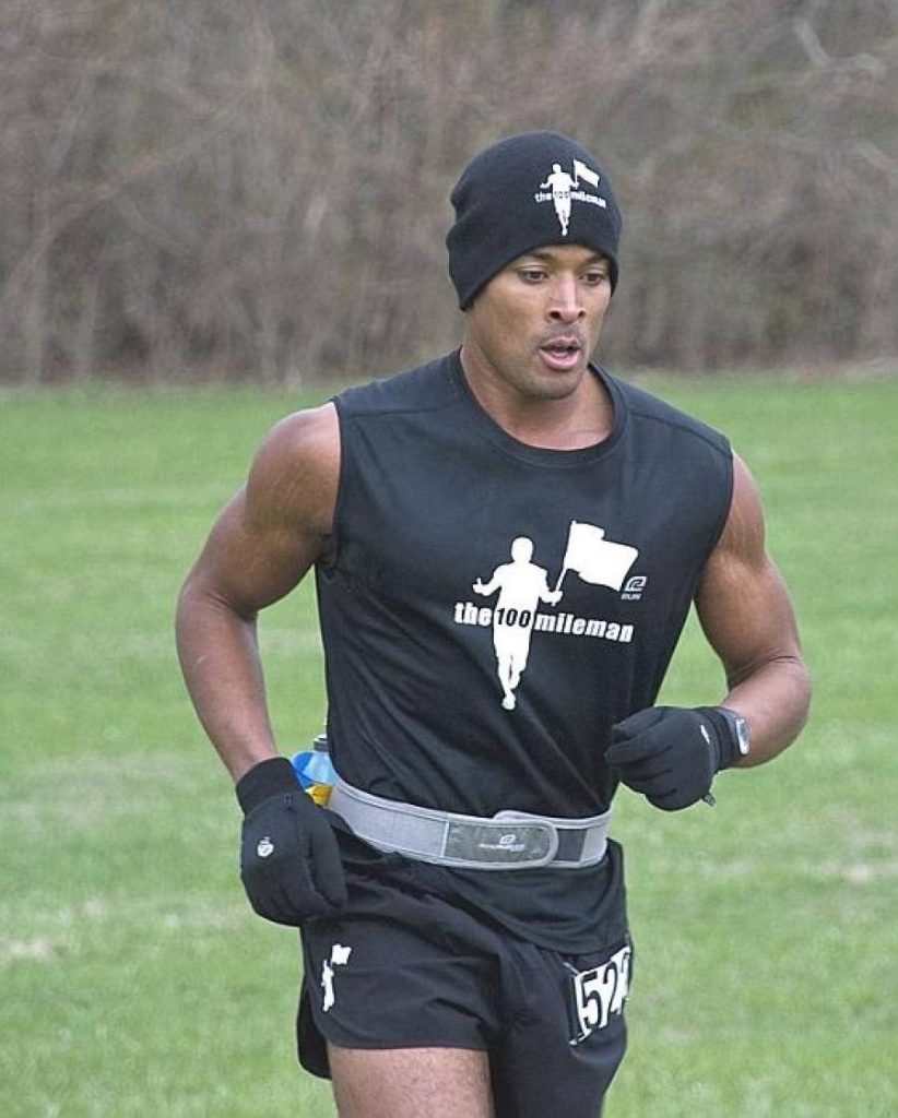 David Goggins intense mid-run action in The 100 Mileman gear outdoors motivational wallpaper