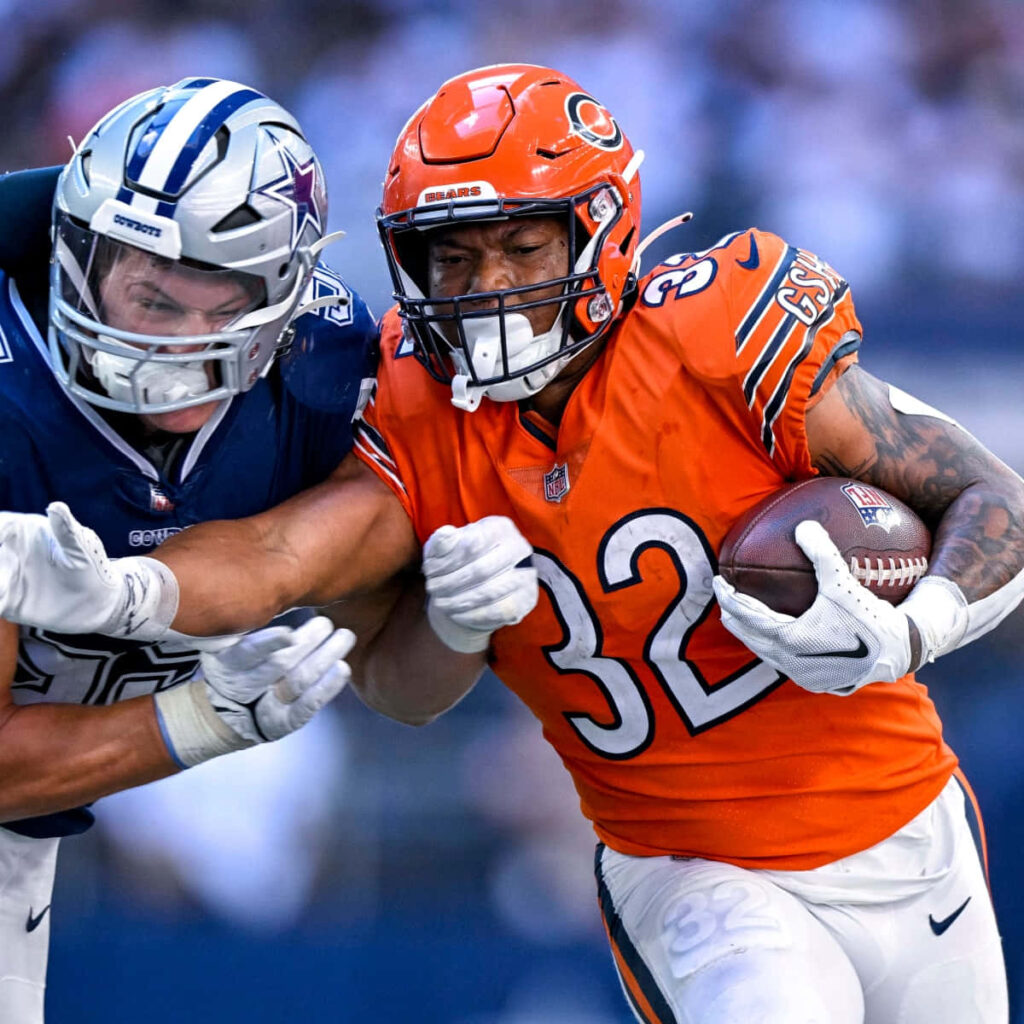 David Montgomery in Chicago Bears uniform breaking tackle by Dallas Cowboys defender NFL action Wallpaper
