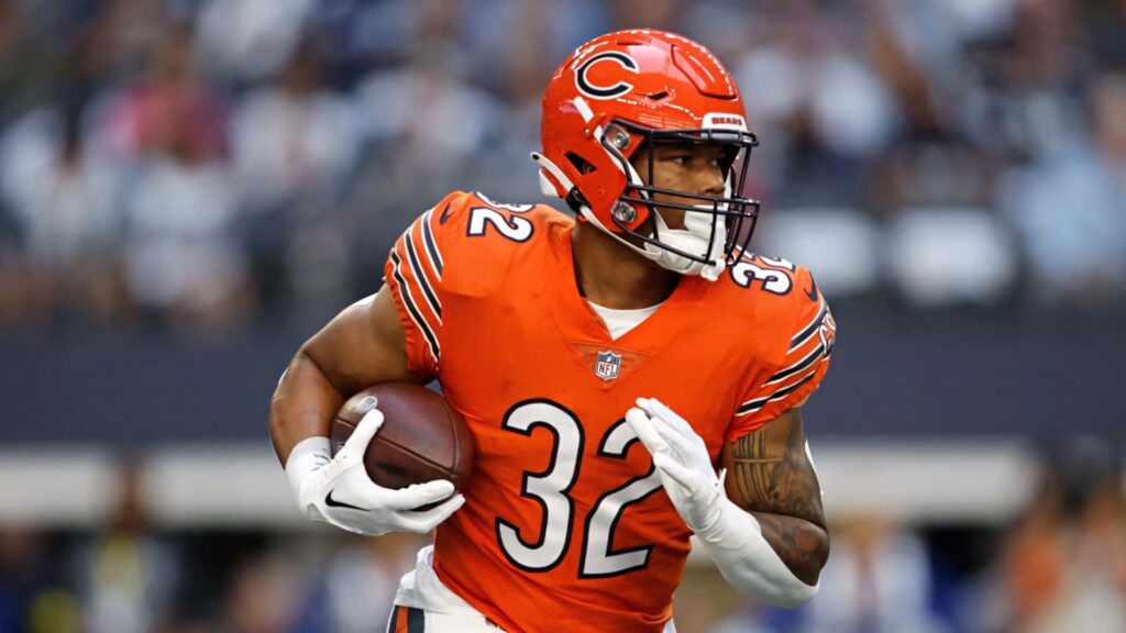 David Montgomery Chicago Bears running strong with football in orange uniform stadium background Wallpaper