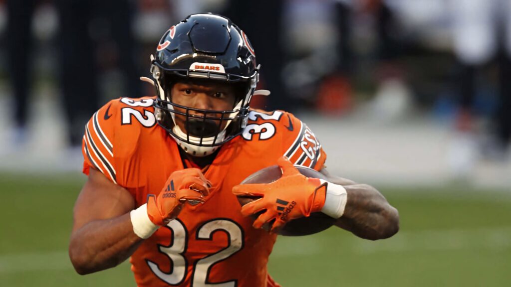 David Montgomery Chicago Bears running back in orange uniform charging with football mid-play Wallpaper