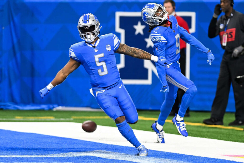 David Montgomery celebrating touchdown in vibrant blue Detroit Lions uniform dynamic wallpaper
