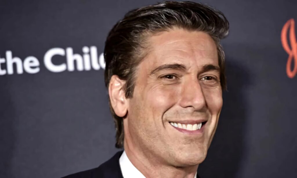 Close-up of David Muir smiling warmly with a professional confident expression and soft background Wallpaper