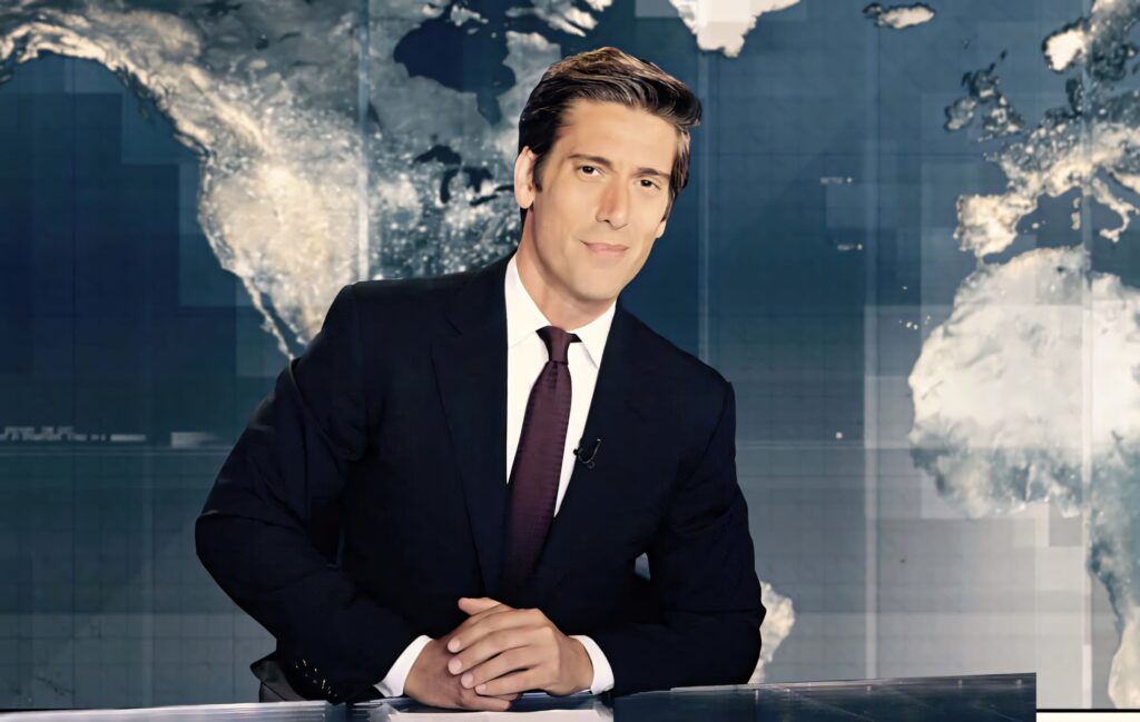 David Muir in professional suit at news desk with world map backdrop in modern newsroom Wallpaper