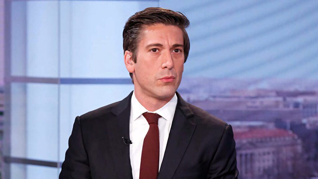 David Muir in sharp suit with serious expression in modern studio background wallpaper