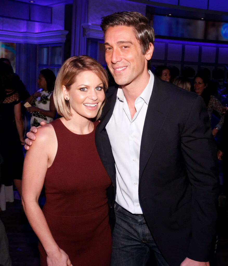 David Muir and Candace Cameron Bure smiling at elegant evening event with blue purple background Wallpaper