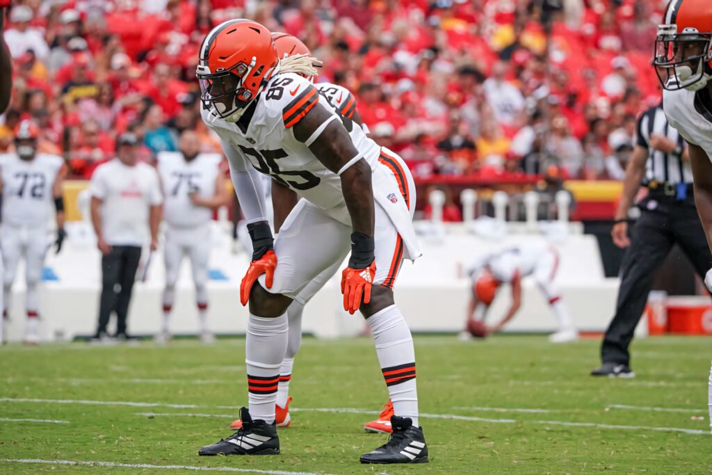 David Njoku in Cleveland Browns uniform ready on field with vibrant orange helmet game day focus Wallpaper