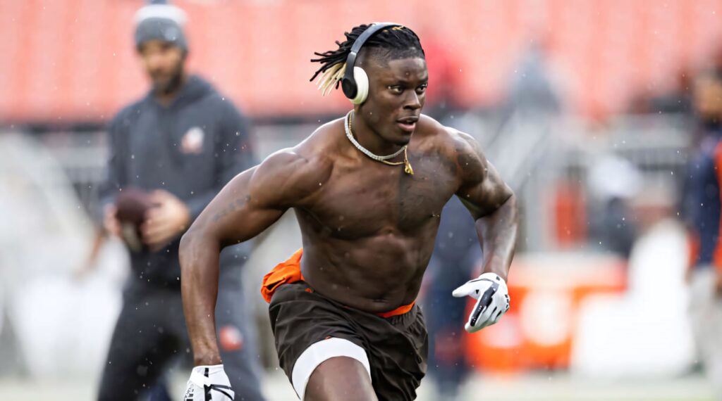 David Njoku training outdoors in Browns gear headphones showing athletic build and focus Wallpaper