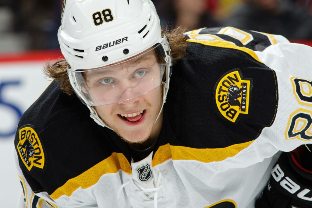 David Pastrnak Boston Bruins focused mid-game vs Arizona Coyotes vibrant hockey wallpaper