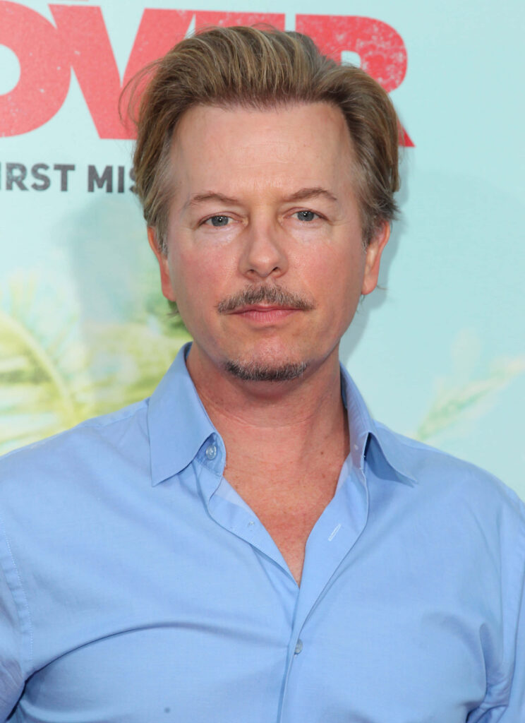 David Spade in light blue shirt on pastel background with calm expression and sharp detail wallpaper