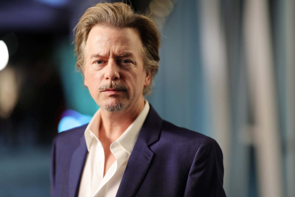 David Spade in sharp blue suit with confident expression modern professional portrait wallpaper