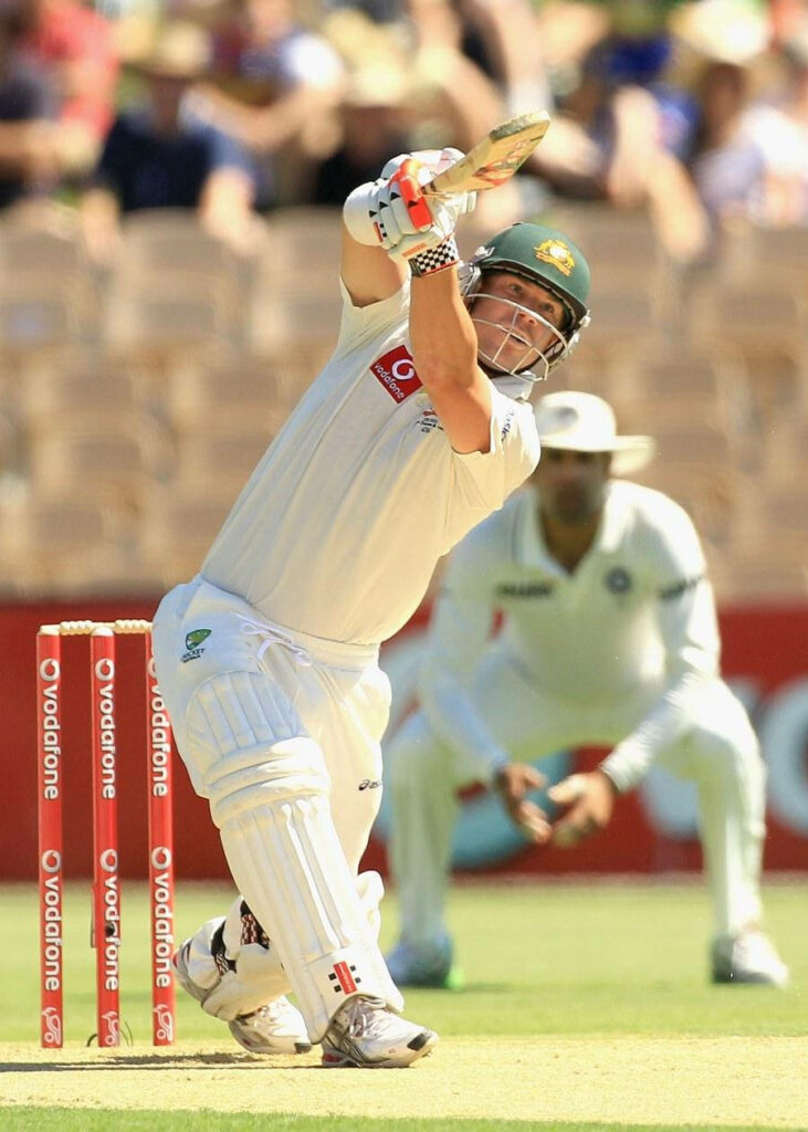 David Warner batting in full whites during test match showcasing focus and cricket athleticism Wallpaper