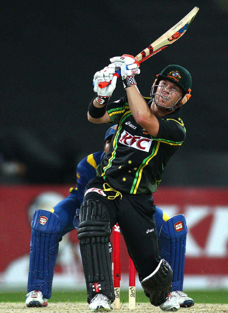 David Warner in black cricket uniform batting with intense focus on vibrant dynamic cricket field Wallpaper