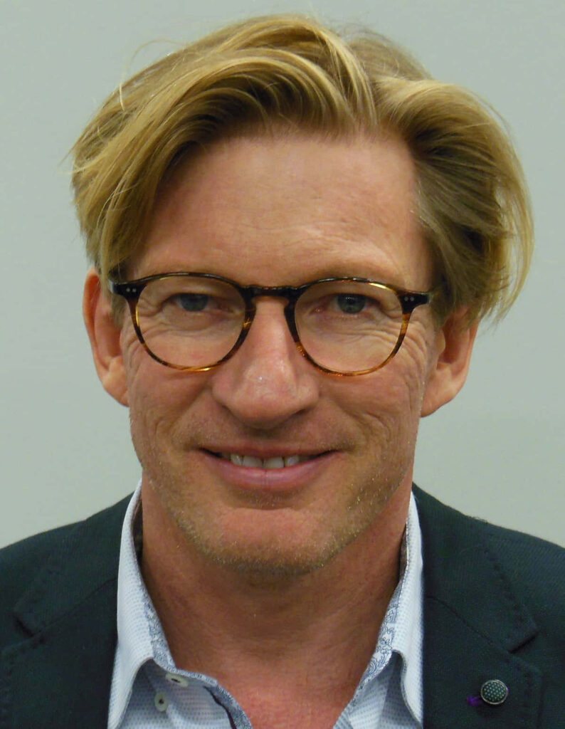 Close-up portrait of David Wenham with round glasses and casual hairstyle on neutral background Wallpaper