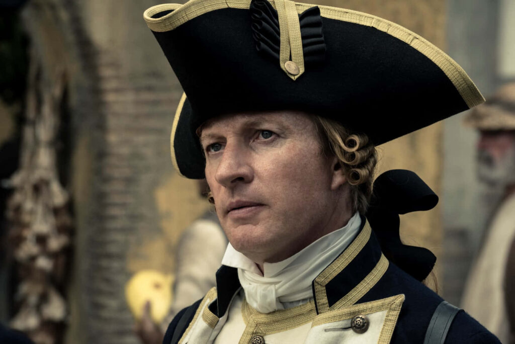 David Wenham in historical military uniform with navy gold officer hat on blurred period background Wallpaper
