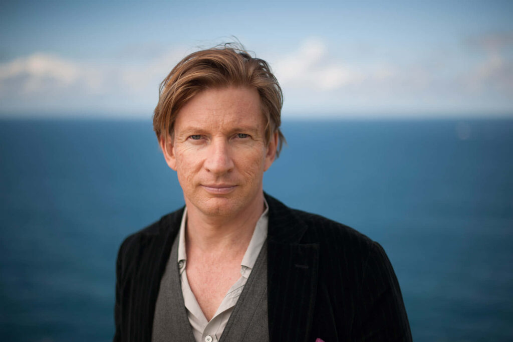 David Wenham portrait calm expression ocean background black jacket natural lighting Wallpaper