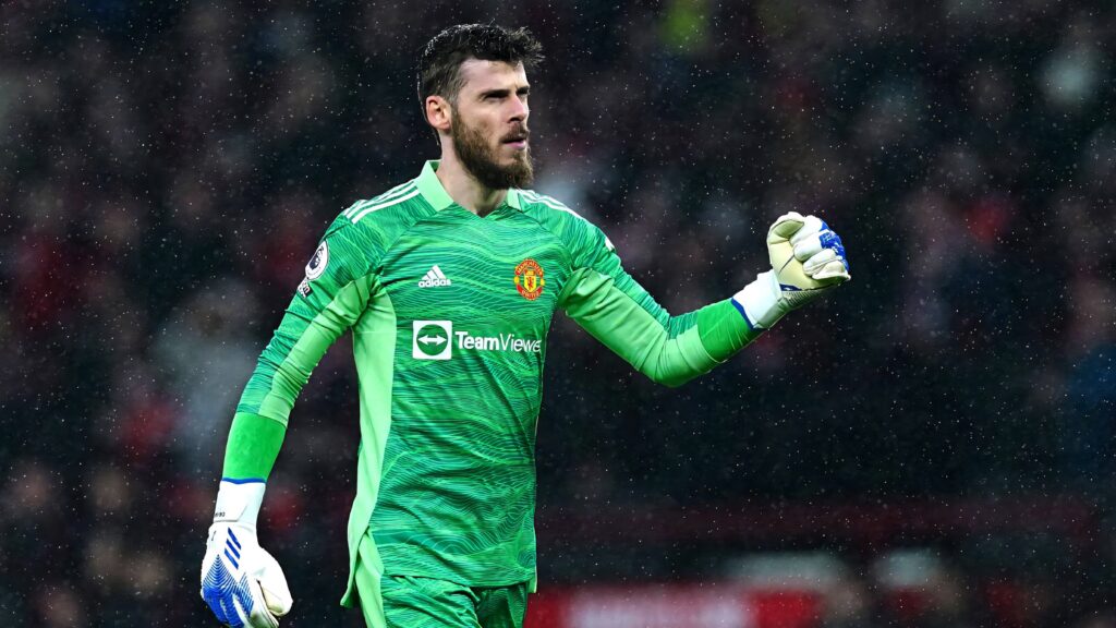David de Gea in bright green Manchester United goalkeeper kit celebrating under stadium lights Wallpaper