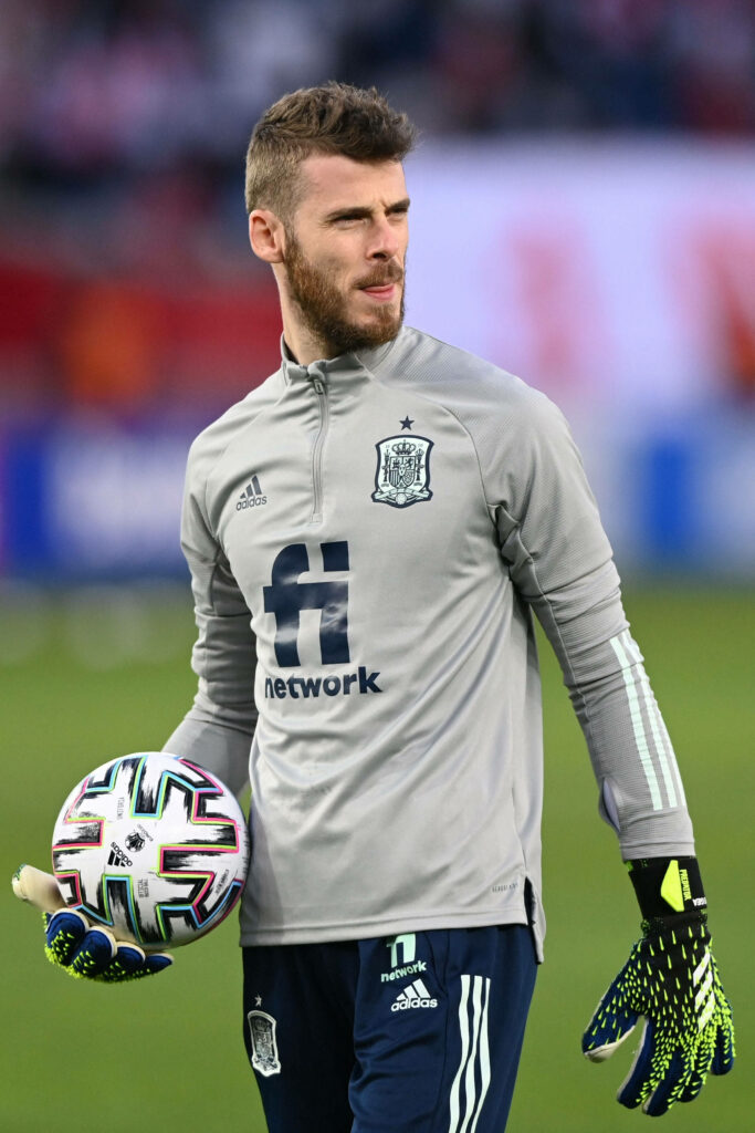 David de Gea in gray Spain goalkeeper kit holding soccer ball on field focused athletic wallpaper