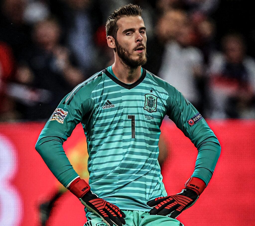 David de Gea in green Spain goalkeeper jersey with red gloves focused in blurred stadium background Wallpaper