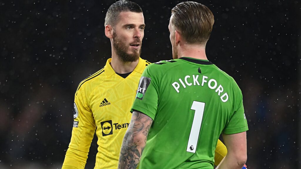 David de Gea in yellow kit faces Jordan Pickford in green goalkeepers intense Premier League match Wallpaper