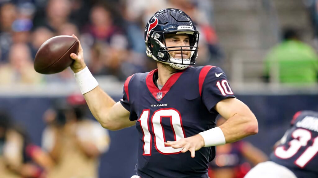 Davis Mills Houston Texans quarterback throwing football mid-action vibrant team colors wallpaper