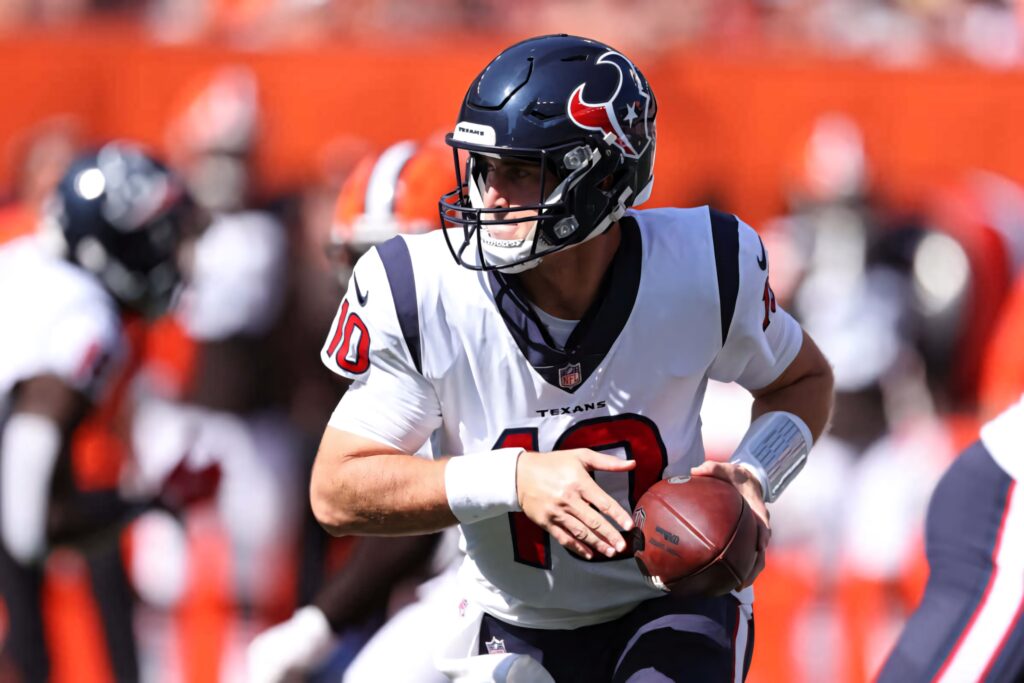 Davis Mills Houston Texans white uniform helmet focused mid play vibrant stadium background wallpaper