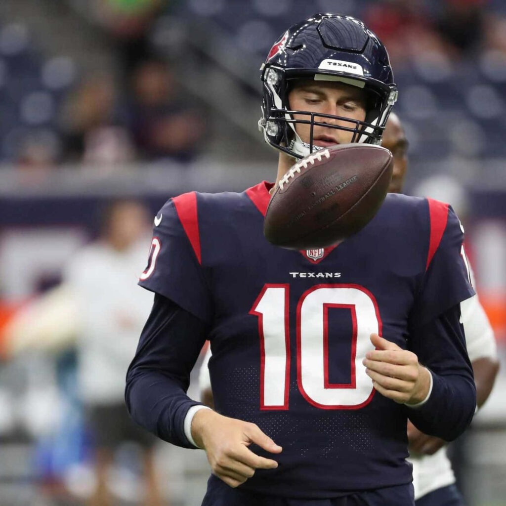 Davis Mills Houston Texans number 10 quarterback warming up catching football in NFL stadium Wallpaper