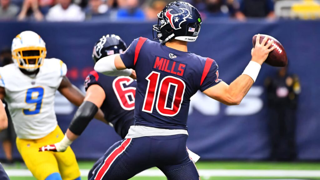 Davis Mills Houston Texans quarterback mid throw NFL game navy red uniform dynamic action Wallpaper