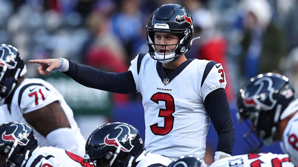 Davis Mills Houston Texans quarterback in white red uniform leads offense in vibrant stadium scene Wallpaper