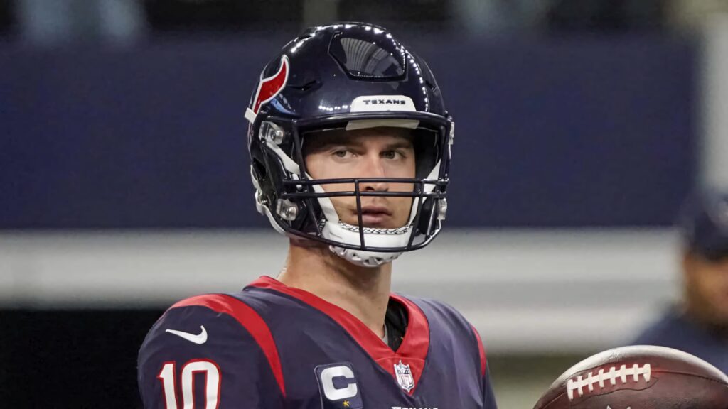 Davis Mills Houston Texans quarterback in navy blue red white uniform holding football ready to play Wallpaper