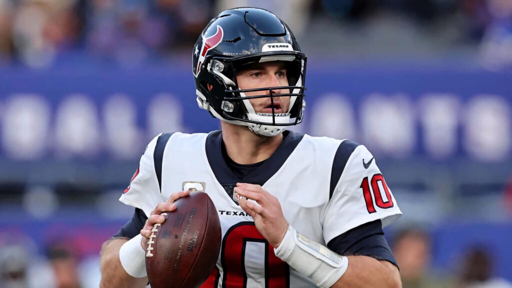 Davis Mills Houston Texans quarterback in number 10 jersey ready to throw football in stadium Wallpaper