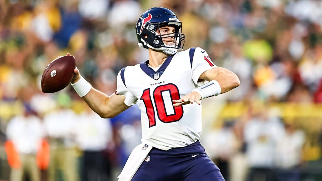Davis Mills mid-throw in Houston Texans number 10 uniform vibrant NFL action wallpaper background
