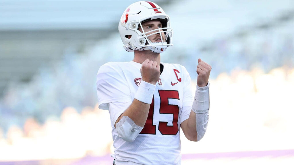 Davis Mills in white Stanford football uniform with helmet showing focused confident quarterback pose Wallpaper
