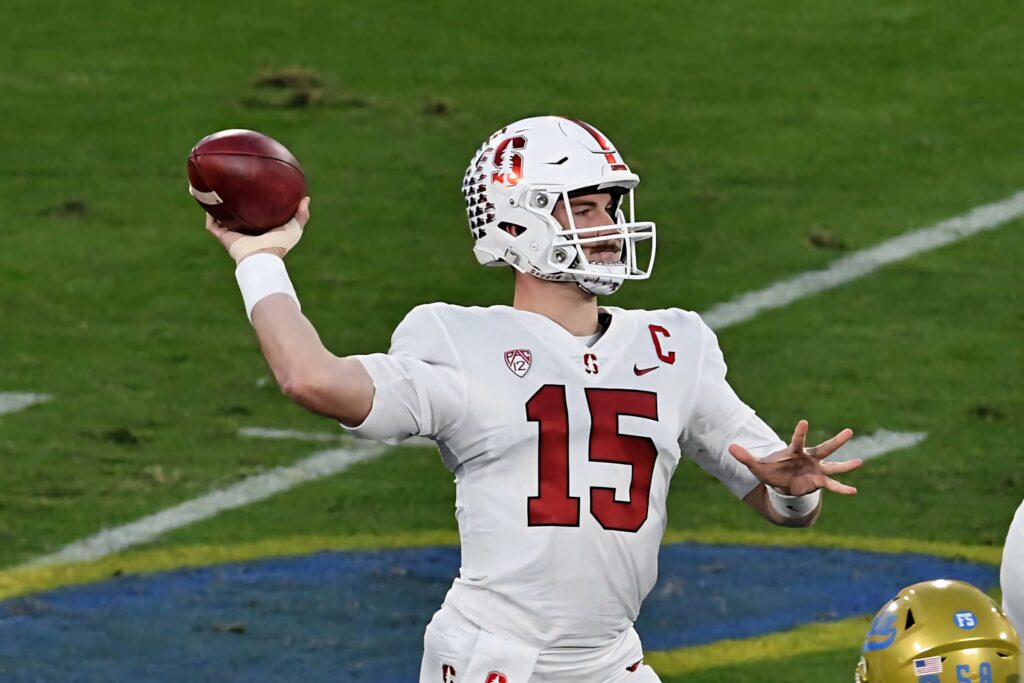 Davis Mills Stanford quarterback throwing football on green field action wallpaper background