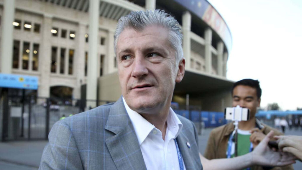Candid wallpaper of Davor Šuker in outdoor stadium interview with media and natural lighting