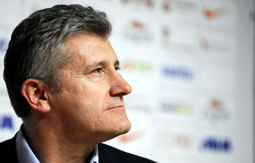 Davor Šuker at Croatia football press conference with natural light and focused thoughtful expression Wallpaper