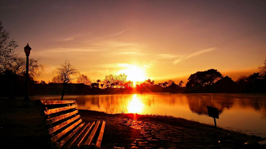 Glimmers of Serenity: Capturing the Golden Hues of a Tranquil Lake at Sunrise Wallpaper