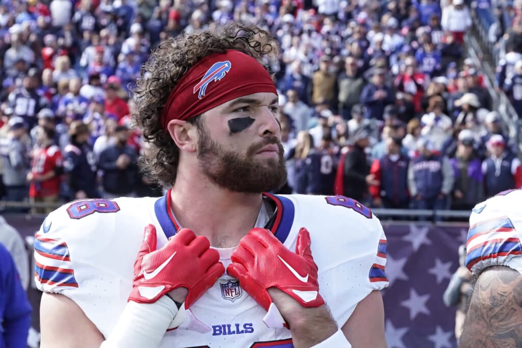Dawson Knox in Buffalo Bills uniform with red gloves focused before game in packed stadium Wallpaper