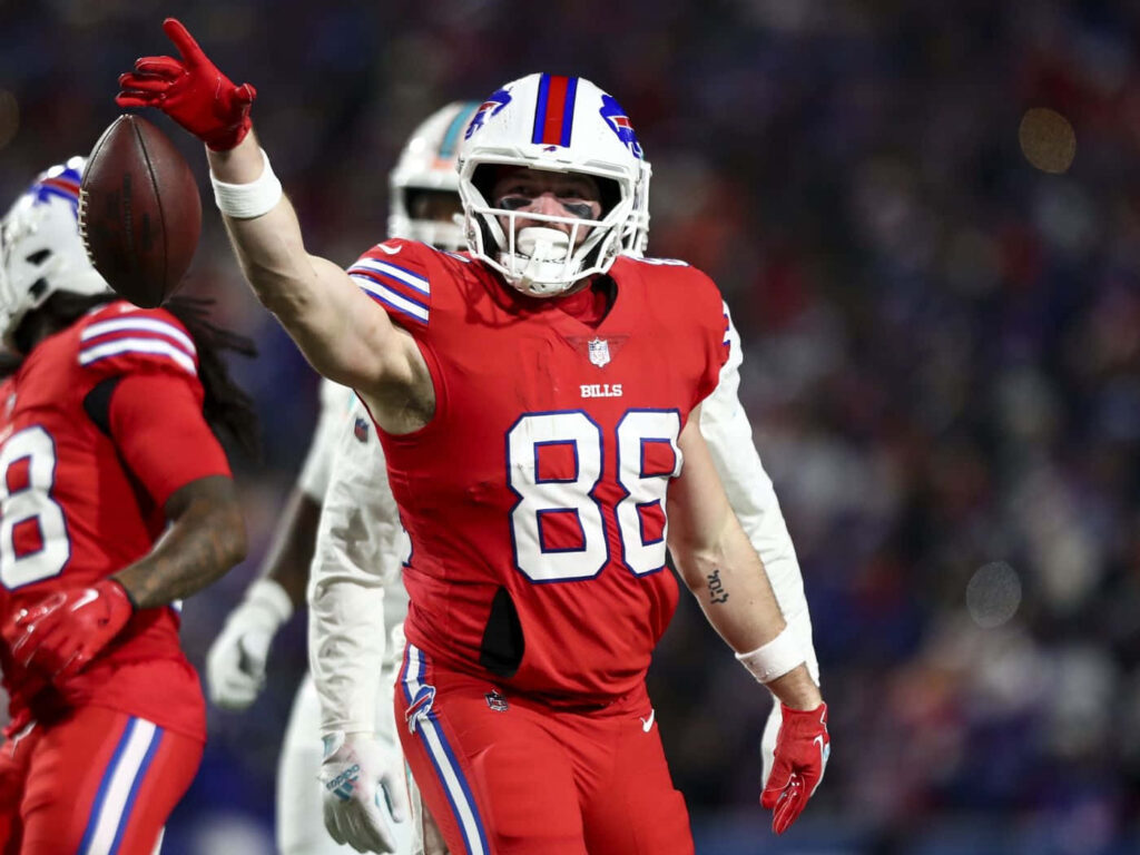 Buffalo Bills tight end Dawson Knox celebrates touchdown in red uniform stadium background Wallpaper