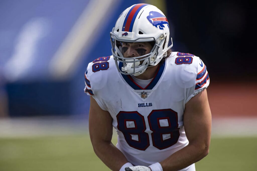 Buffalo Bills tight end Dawson Knox in white blue uniform focused during intense gameplay Wallpaper