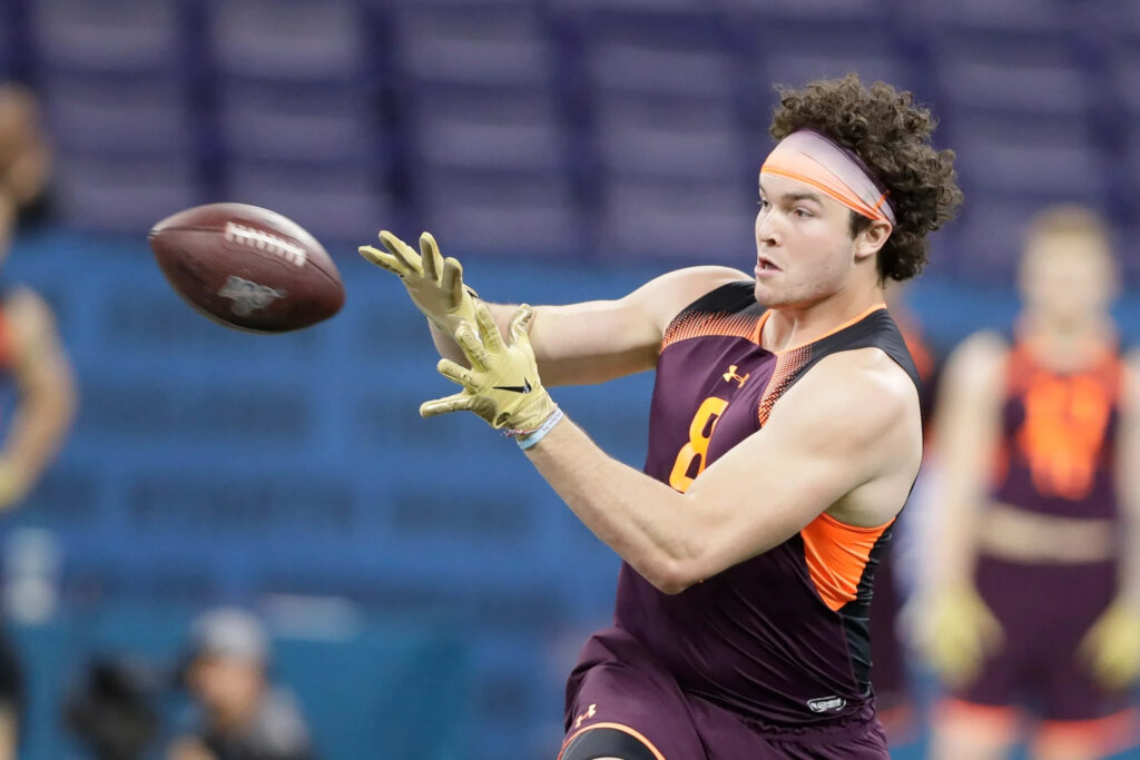 Dawson Knox intense football drill catch in Under Armour gear vibrant athletic training background Wallpaper