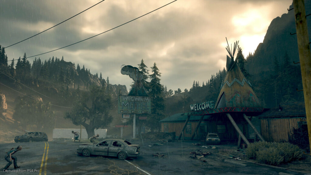 Days Gone wallpaper showing Deacon St John at rain-soaked roadside motel with wrecked cars and mountains