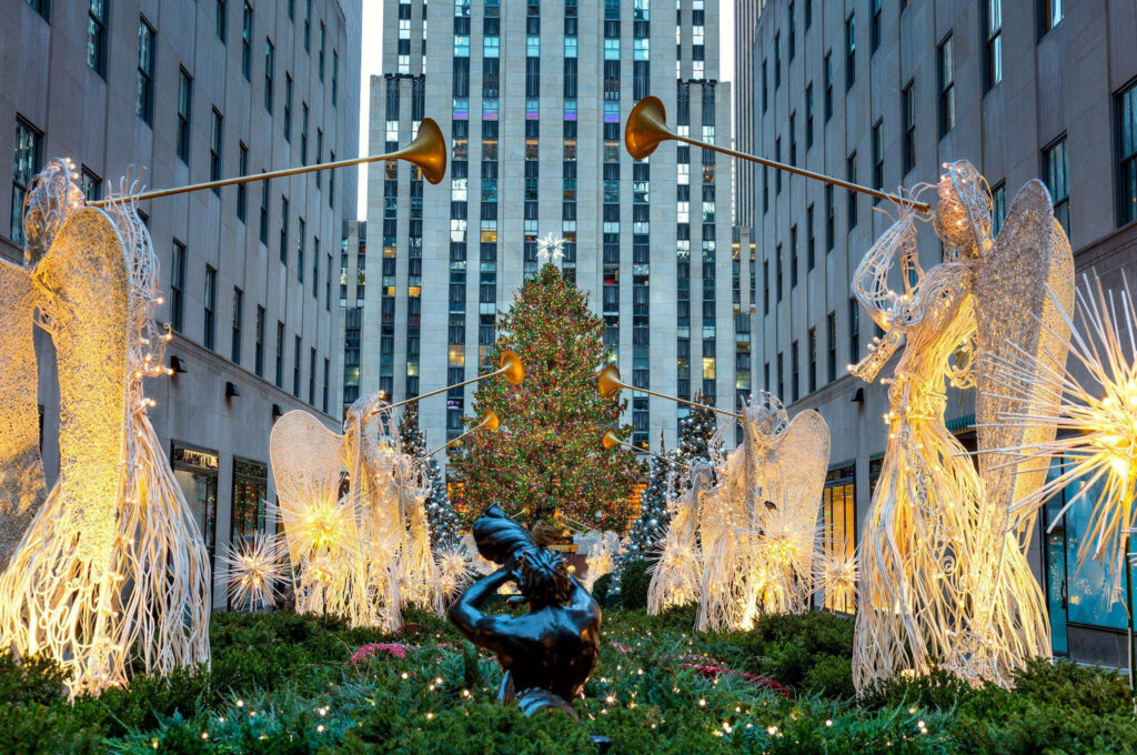 Daytime Holiday Scene at Rockefeller Center with Angel Sculptures Wallpaper