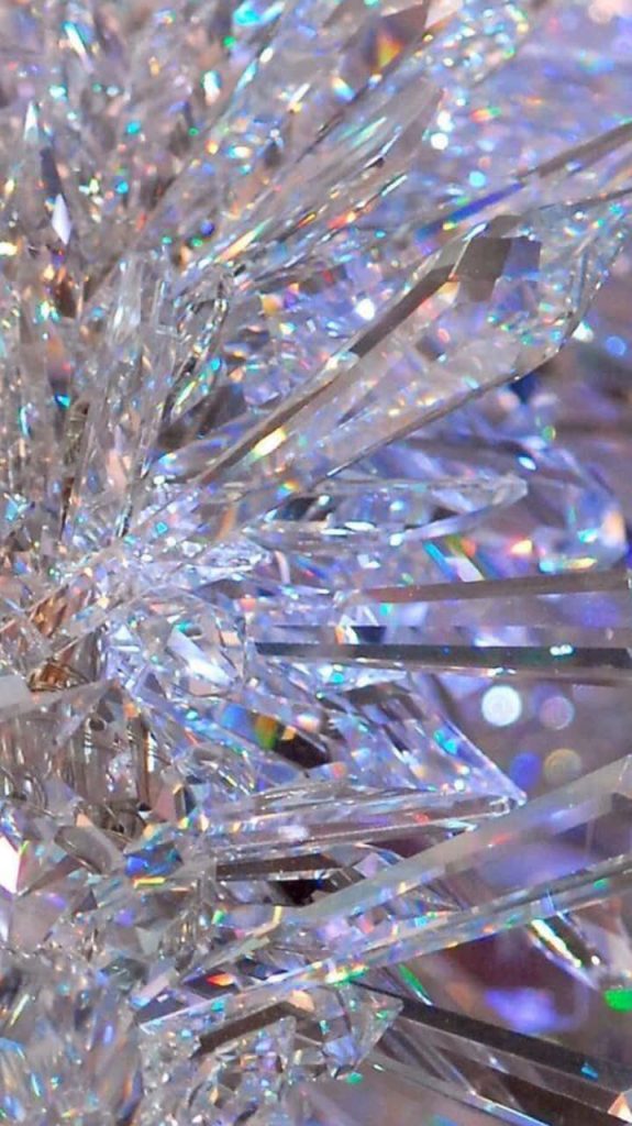 Abstract wallpaper with sharp crystalline shards and vibrant rainbow holographic light rays