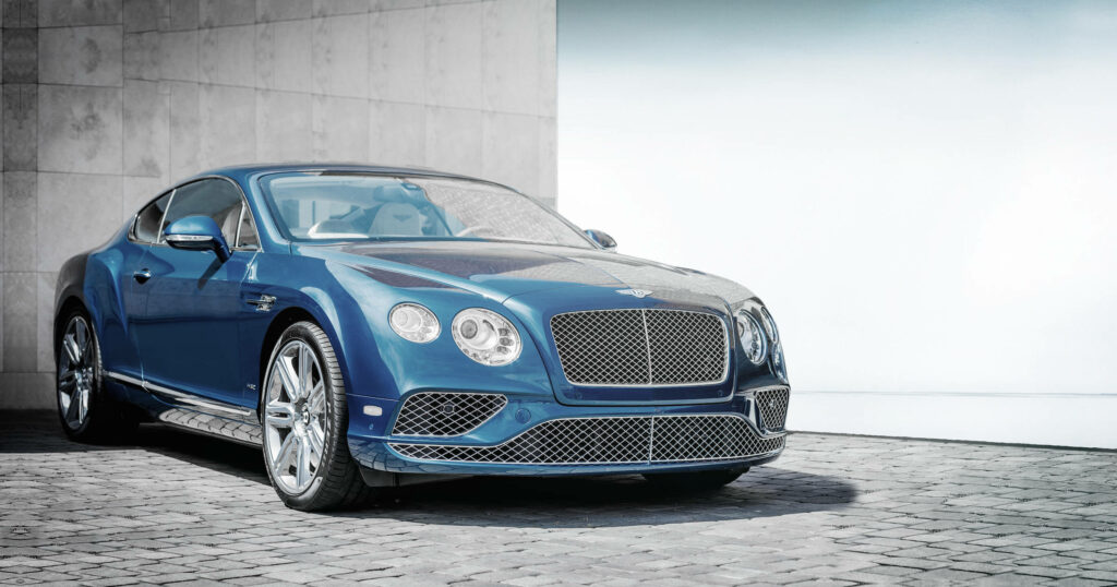 Brilliant Blue Bentley on a Captivating Charcoal Backdrop Wallpaper
