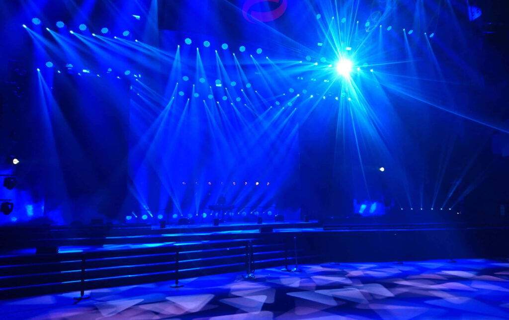 Captivating Light Show: A Dark Stage Enveloped in Smoky Blue Hues Wallpaper