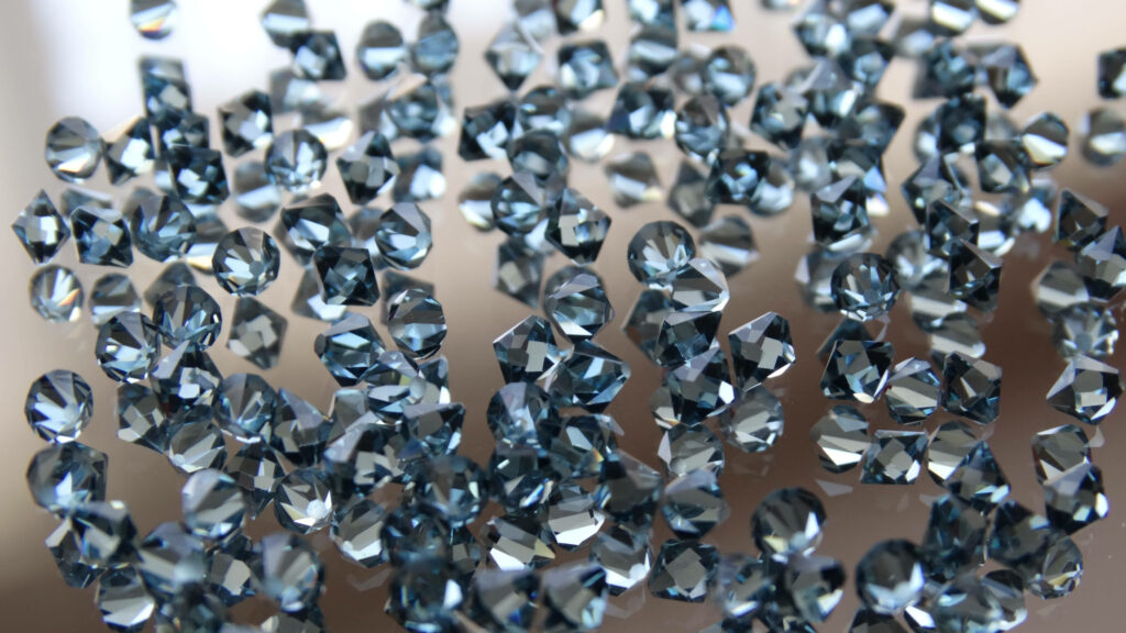Diamond Extravaganza: Captivating 4D Ultra HD Image Showcasing Gleaming Gems Adorning a Glass Table Wallpaper