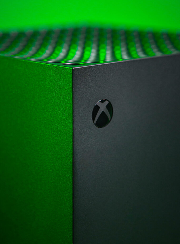 Xbox One X Console Edge Illuminated in Green Light Wallpaper