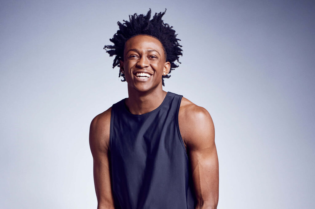 De'Aaron Fox confident basketball player photoshoot with athletic build and expressive smile wallpaper