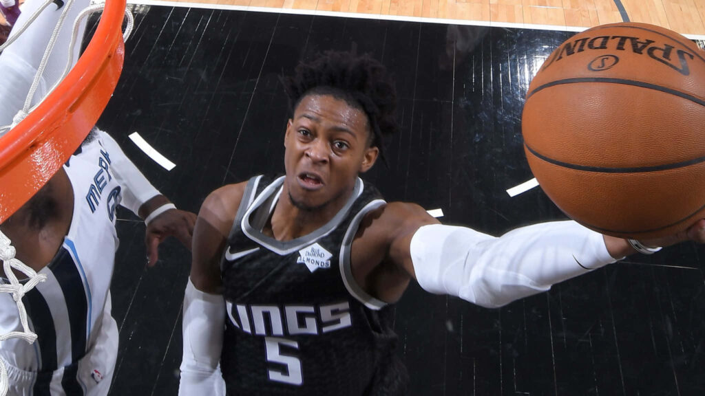 DeAaron Fox Sacramento Kings soaring layup intense focus dynamic basketball wallpaper background